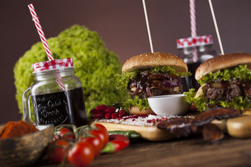 Home made burgers on wooden background