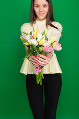 Beautiful girl with a bouquet of tulips