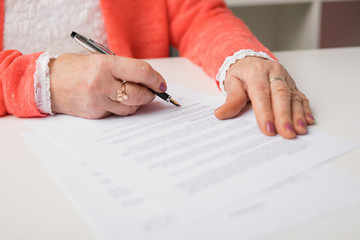 Senior signing papers at the office