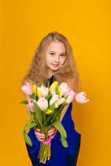 Beautiful girl with a bouquet of tulips