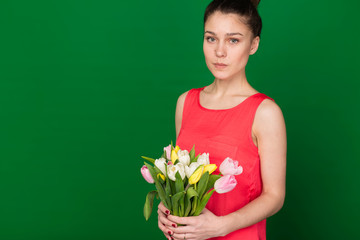 Beautiful girl with a bouquet of tulips