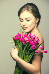 Fototapeta premium Spring portrait of young beautifull woman with tulip flowers