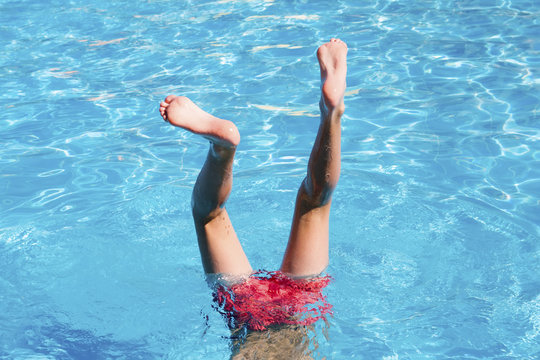 Teenager Has Fun In Waterpark.  Feet In The Pool Close Up