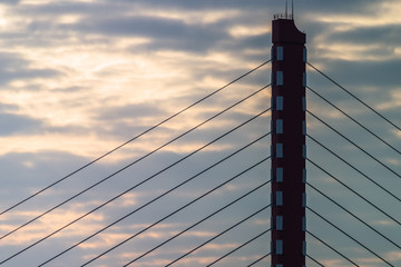 high section of a modern cable stayed bridge on the sky background.