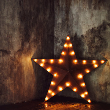 Star of lights on the textured background, designer lamp