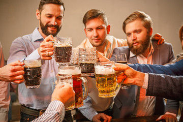 Group of friends enjoying evening drinks with beer