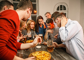 Group of friends enjoying evening drinks with beer