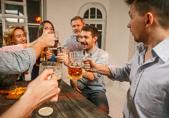 Group of friends enjoying evening drinks with beer