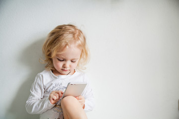 beautiful little girl with a smartphone