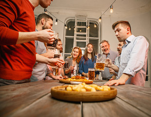 Group of friends enjoying evening drinks with beer