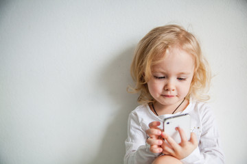 beautiful little girl with a smartphone