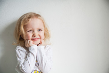 Portrait of a emotional beautiful little girl. Isolated on white background.