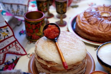 tasty fish caviar on pancakes lies in Carnival
