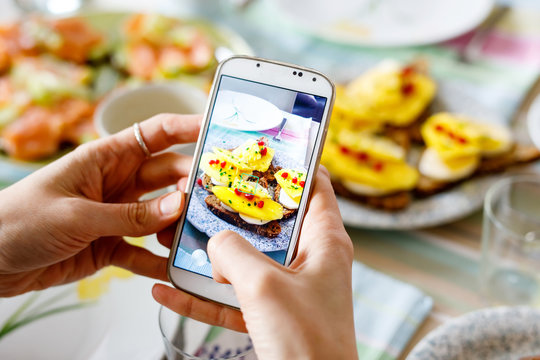 Smartphone taking picture from organic healthy sandwiches.
