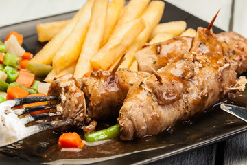 Pork rolls with french fries with vegetable