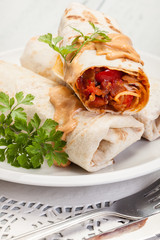 Mexican burritos wraps with mincemeat, beans and vegetables