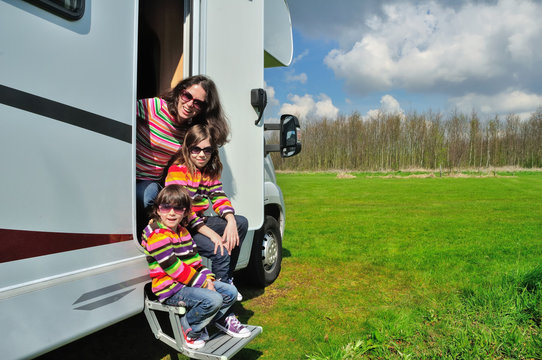 Family vacation, RV (camper) travel with kids, happy mother with children have fun on holiday trip in motorhome
