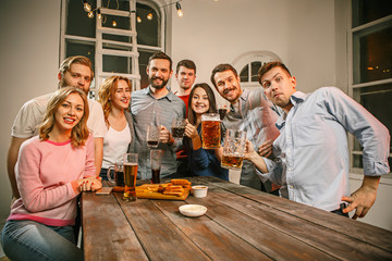 Group of friends enjoying evening drinks with beer