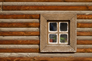 ancient window in the house , a fragment of a log cabin , a wooden hut , Ukrainian style , historical reenactment 