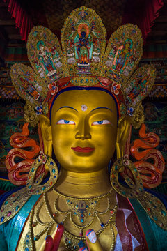 LEH, INDIA - MAY 9, 2015: Image of Lord Buddha in Thiksay Tibetan Buddhist monastery, located on top of a hill in Thiksey village, near Leh in Ladakh, India. Visitors reguraly come to pray here.