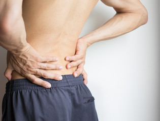 Fototapeta premium Man touching his back because of severe back pain