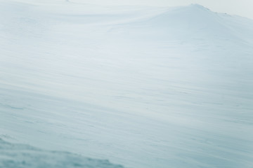 A beautiful, minimalist landscape of snowy Norwegian hills. Clean, light, high key, decorative look.
