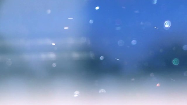 Abstract winter background with snow particles in bokeh