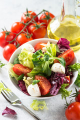 Fresh salad in a bowl. Green leaves tomatoes mozarella. Organic diet food