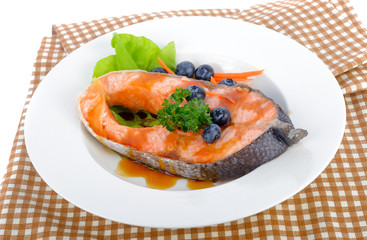 salmon steak with vegetables and fruit.