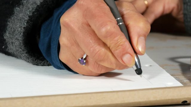 close up of hand of woman taking notes