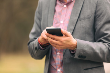 Handsome businessman using smartphone.