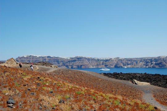 Coast of Santorini volcano, Greece. Caldera. Lifeless emissions of basalt, a reminder of the eruption. The view from the shore/ From a trip to the Cycladic Archipelago