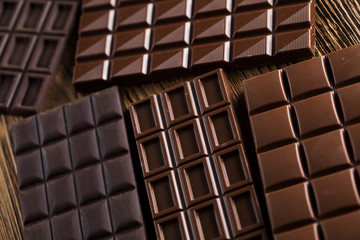 Chocolate bar, candy sweet, dessert food on wooden background