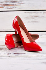 Red shoes on wood. Stylish women's footwear.