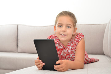 Toddler girl playing games on her tablet