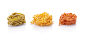 Italian pasta tagliatelle, with chilli and spinach, isolated on white background