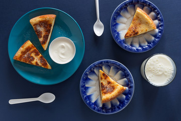 Baked pudding with milk on blue background
