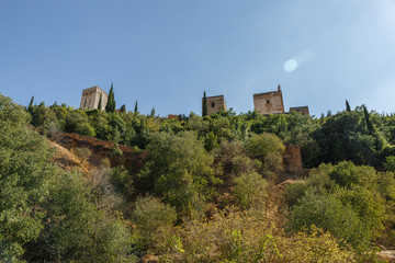 Fototapeta na wymiar View from below of some towers of The Alhambra, Granada, Spain