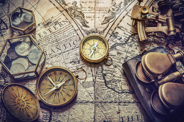 Fototapeta na wymiar Compass, sextant and old coins on vintage map. Retro style.