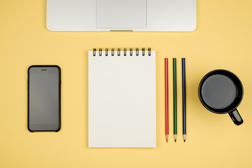 Modern office desk table with laptop, blank notebook page