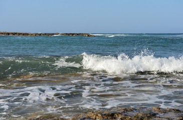 Fototapeta na wymiar The waves of the Mediterranean Sea off the coast of Cyprus