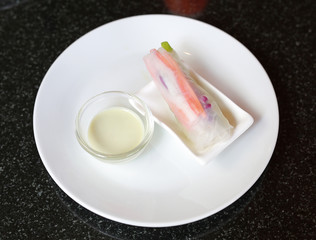 Fresh vegetable salad roll in noodle tube on dish
