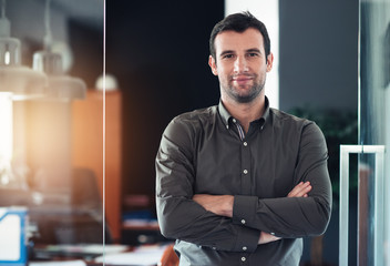 Successful businessman standing in his office