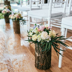Wedding bouquet in timber vase on floor in ceremony place