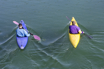 Two rowers with canoe recreate in a lake