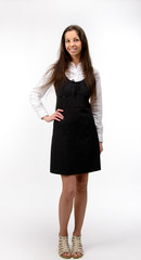 Beautiful young business woman standing, on white