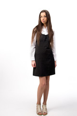 Beautiful young business woman standing, on white