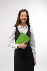 Attractive young business woman holding a green digital tablet, on white