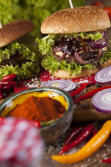 Close-up of home made burgers, wooden desk background