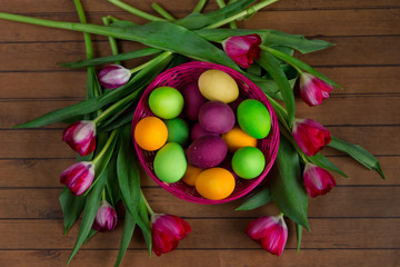 Tulip wreath aruond easter colorful eggs in basket